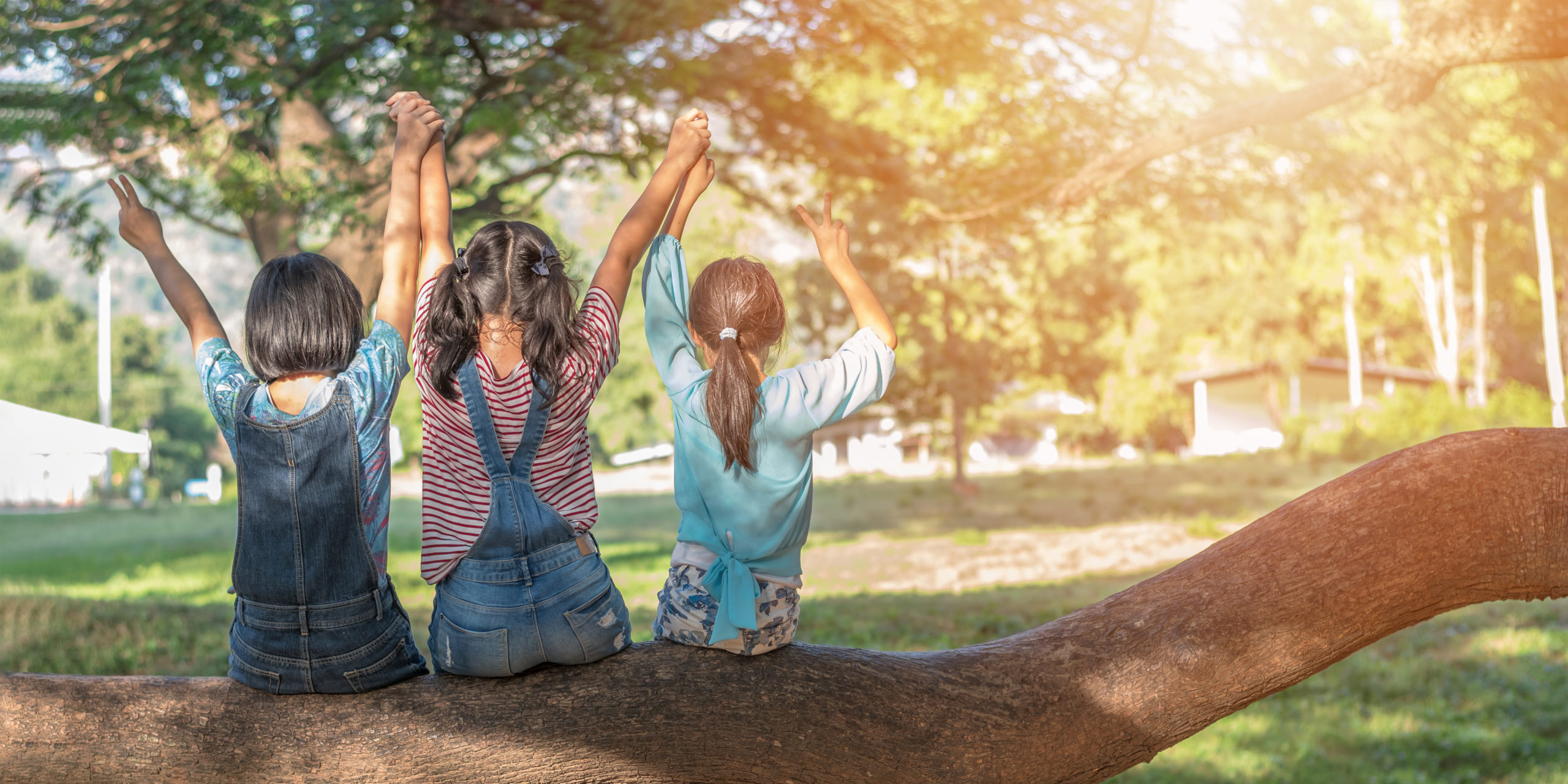 Children friendship concept with happy girl kids in the park hav