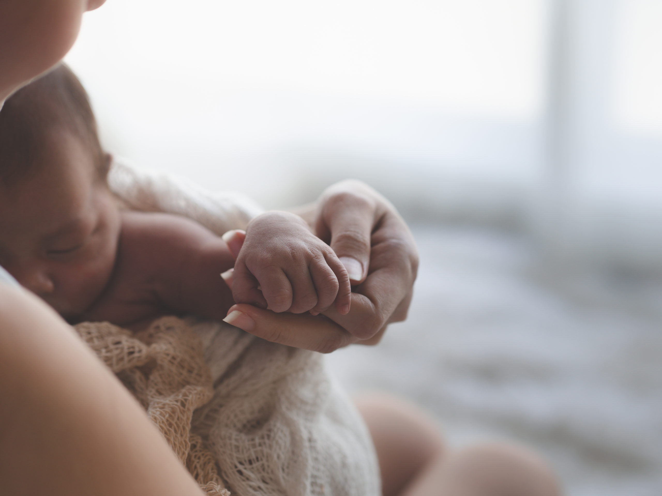 Close up Mother holding hands Asian female newborn baby and sun